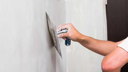 What is the Proper Method for Skim Coating a Wall or Ceiling