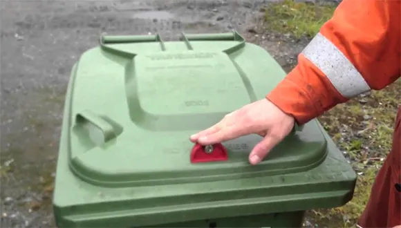 How does a dumpster gravity lock work