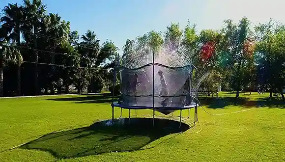 Outdoor trampoline water sprinkler