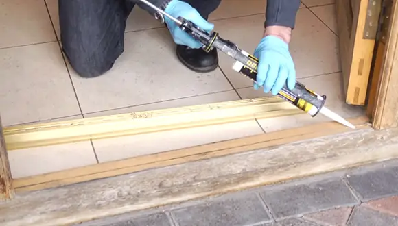 What Type of Adhesive Should I Use for Sealing Door Thresholds on Concrete Slab