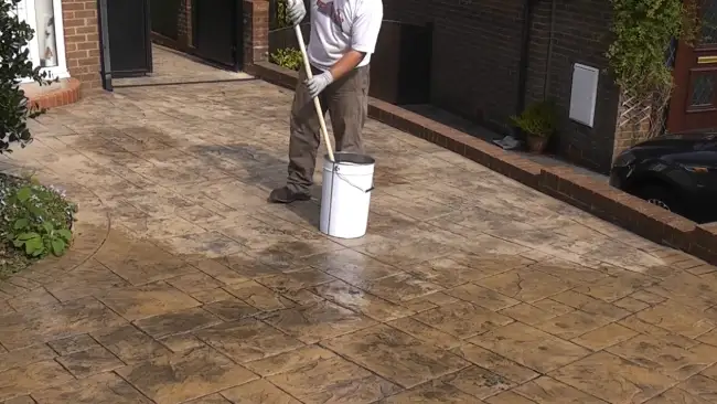 Does spraying or rolling concrete sealer affect the drying time